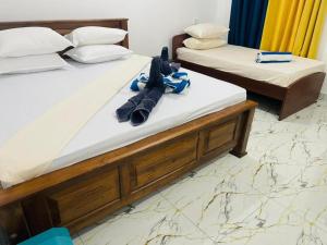 two beds with flip flops on them in a room at Pigeon Island Beach View Villa - Nilaveli in Nilaveli