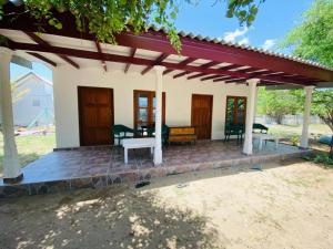 a porch of a house with a table and chairs at Pigeon Island Beach View Villa - Nilaveli in Nilaveli +6 photos