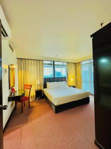 a large hotel room with a bed and a desk at Luxy Service Apartment at Times Square KL in Kuala Lumpur