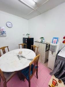 a kitchen with a table with chairs and a refrigerator at Home in Sepang, Homestay Mokhzan in Sepang +11 photos