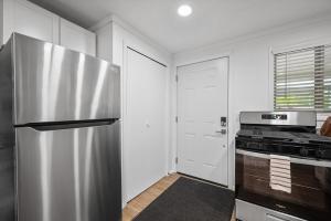 a kitchen with a stainless steel refrigerator and a stove at Modern and Quiet One Bedroom Apartment in Gibsonia, Pittsburgh, Unit 2 in Bakerstown