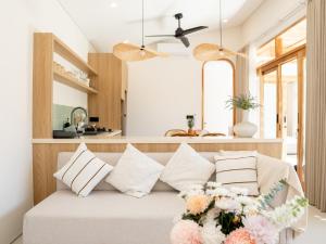 a living room with a couch with flowers on it at Aquae Villas - Lavanda - Chic Villa 2 bdr - pool - Kuta Lombok in Kuta Lombok +26 photos