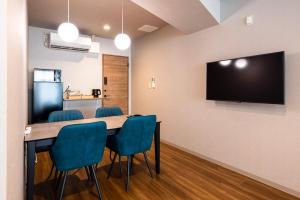 a conference room with a table and chairs and a flat screen tv at Amp Flat Arc Bliss 2B in Chikushino