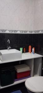 a bathroom with a sink and a toilet at Minha morada in Ananindeua