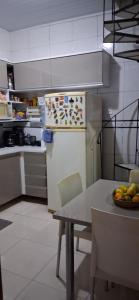 a kitchen with a table with a plate of fruit at Minha morada in Ananindeua +6 photos