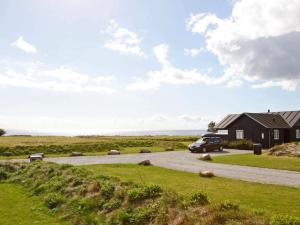 a car parked on a road next to a house at 8 person holiday home in Nysted-By Traum in Nysted