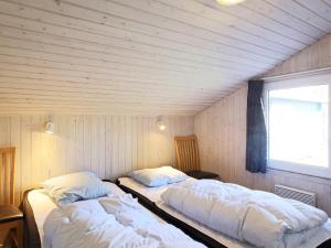a room with two beds in a room with a window at 4 star holiday home in Væggerløse in Bøtø By