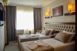 Postel nebo postele na pokoji v ubytování Mekke Hotel Istanbul