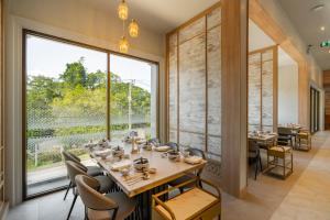 ein Esszimmer mit Tisch und Stühlen und einem großen Fenster in der Unterkunft AZ Sunrise Resort & Fitness Club in Layan Beach