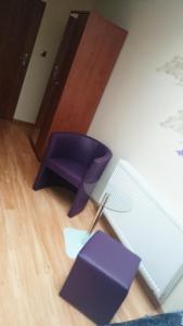 a purple chair sitting on the floor in a room at Hotel Restauracja Księżycowa in Siedlce