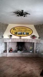 a living room with a fireplace with a sign above it at Agriturismo La Vite e L'Ulivo in Baschi