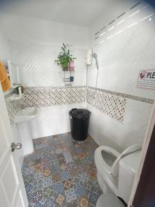 a bathroom with a toilet and a sink at Sea House Koh Chang in Ko Chang