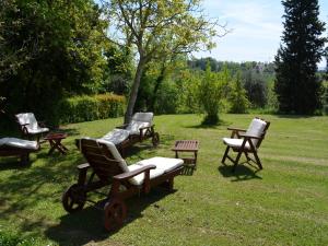 a group of chairs sitting in the grass at Italian Holiday home in Vergiano
