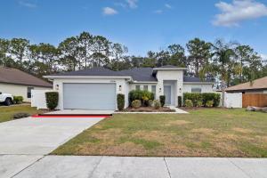 a large white house with a garage at Spacious Suite in modern house in Orlando