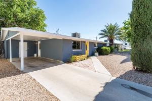 a blue house with a driveway in front of it at Route 66 Hope Ranch House in Kingman
