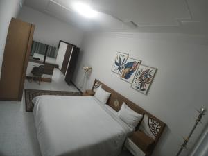 Ένα ή περισσότερα κρεβάτια σε δωμάτιο στο Grand Plaza