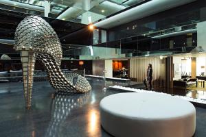 a large lobby with a slide in a building at Troia Design Hotel in Troia