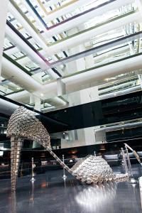 two sculptures in a room with a ceiling at Troia Design Hotel in Troia