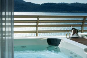 a bath tub with a view of a body of water at Troia Design Hotel in Troia