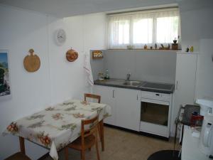 a kitchen with a table and a sink and a table and chairs at Charming Chalet Near Trails in Mörel