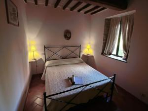 a bedroom with a bed with two lamps and a window at Relax & Unwind in Umbria in Umbertide