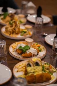 a wooden table with plates of food on it at Khar Hotel in Skardu +13 photos
