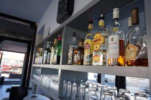 a bar with many bottles of alcohol and glasses at Hôtel Le Nautic in Arcachon