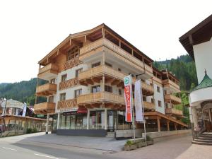 a large building with wooden balconies on a street at Apartment in Gerlos near Ski Lift in Gerlos