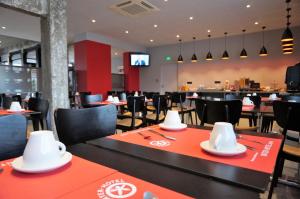 a restaurant with tables and chairs with hats on them at Hôtel Le Nautic in Arcachon