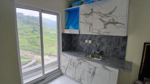 a kitchen with a sink next to a window at Heaven Stay in Murree +53 photos