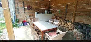 a table and chairs in a room with a wooden wall at Guest house River side Adishi in Adishi +29 photos