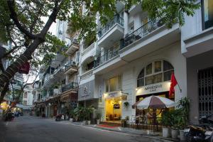 a building with an umbrella on a city street at Hanoi Impressive Hotel in Hanoi