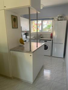 a kitchen with a counter with bananas on it at Pelagos Hill Apartment in Paphos +11 photos