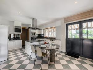 a kitchen with a table and some chairs in it at Alken Farm Stay with Terrace in Alken