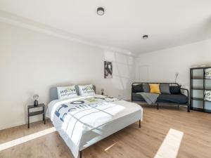 a white bedroom with a bed and a couch at Alken Farm Stay with Terrace in Alken