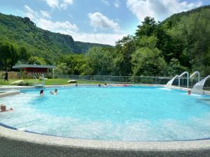 a large swimming pool with people in the water at Villa Rosenburg in Thale