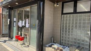 a building with red chairs in front of a window at 心斎橋難波関空直通Ambers 2213 in Wada