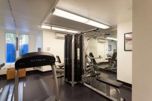 a fitness room with a gym with a treadmill at Ramada Plaza by Wyndham West Hollywood Hotel & Suites in Los Angeles
