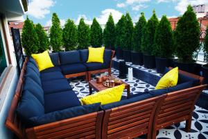 a patio with blue and yellow cushions on a balcony at Tophane Suites in Istanbul