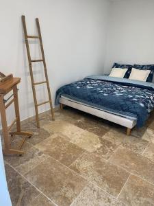 a bedroom with a bed and a ladder and a desk at appartement en centre ville in Sainte-Maxime
