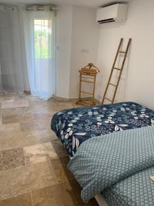 a room with a bed and a ladder and a window at appartement en centre ville in Sainte-Maxime
