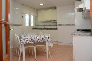 a kitchen with a table with chairs and a table and a table at Brisa Beach in Santa Susanna