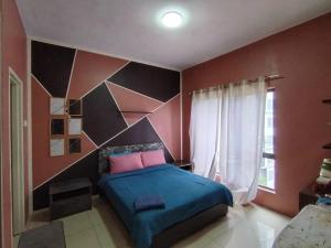 a bedroom with a blue bed and red walls at Pool & Sea View Casa Azalea at Swiss Garden Resort Residence - 2 bedroom apartment in Kuantan +20 photos