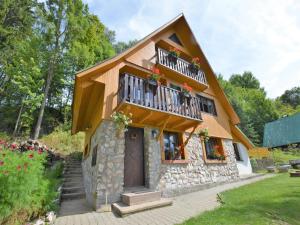 a house with a balcony with flowers on it at Family Chalet in Giant Mountains in Mrklov