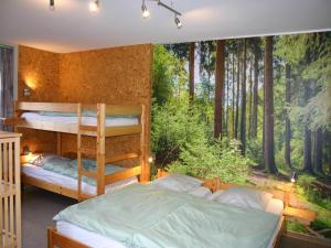 a bedroom with bunk beds in the woods at Home in Vielsalm with Sauna in Vielsalm