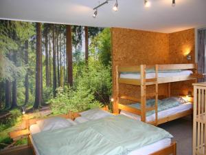 a bedroom with two bunk beds in the woods at Home in Vielsalm with Sauna in Vielsalm +27 photos