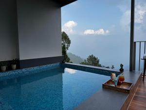 a swimming pool with a view of the mountains at OREN Kasauli in Kasauli