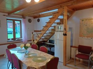 a kitchen and dining room with a table and a staircase at Supieńska Przystań in Supienie