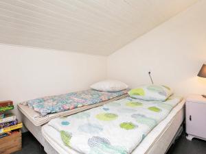 a bed in a room with a mattress at 6 person holiday home in Blokhus in Blokhus