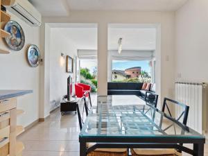a dining room with a glass table in a room at Sunny Villa with Terrace in Comerio